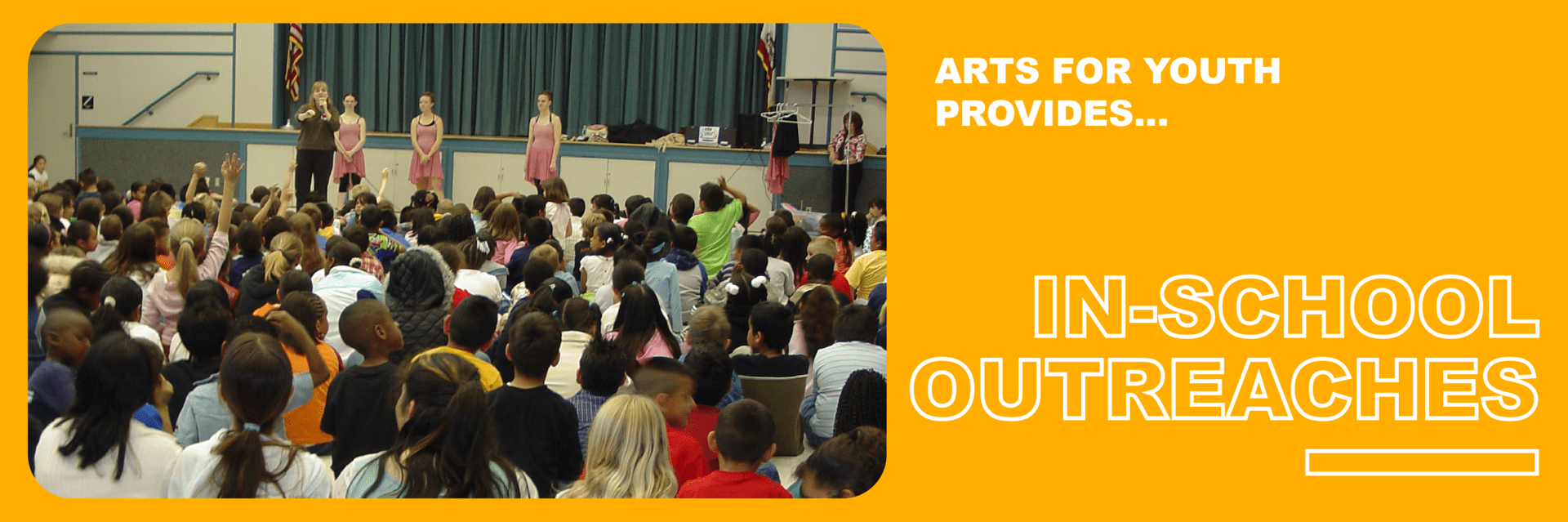 Children watching a school performance on stage.
