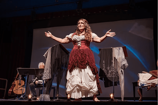 Performer in period costume on stage.
